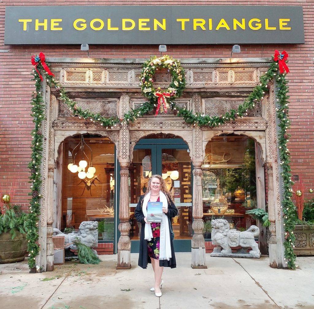 Theresa L. Goodrich at her book launch party for Two Lane Gems, Vol. 1, in front of The Golden Triangle