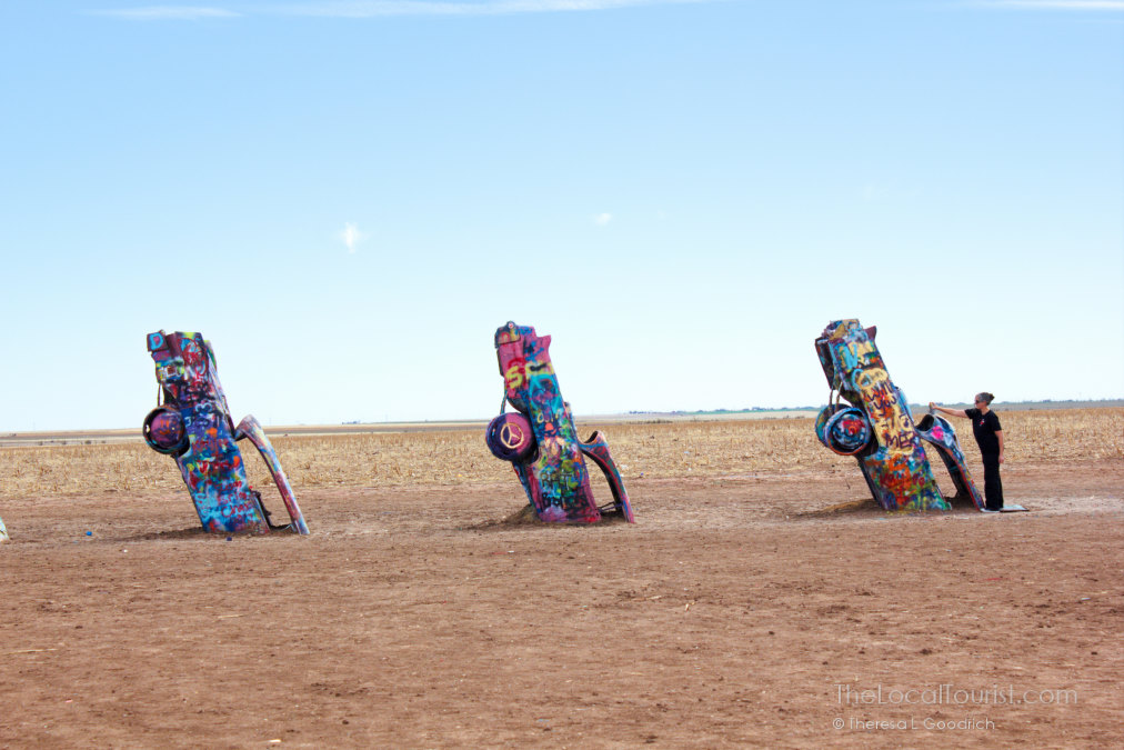 Woman painting a car at Cadillac Ranch