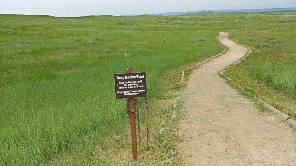Deep Ravine Trail sign warning of steep grades, uneven surfaces, and rattlesnakes