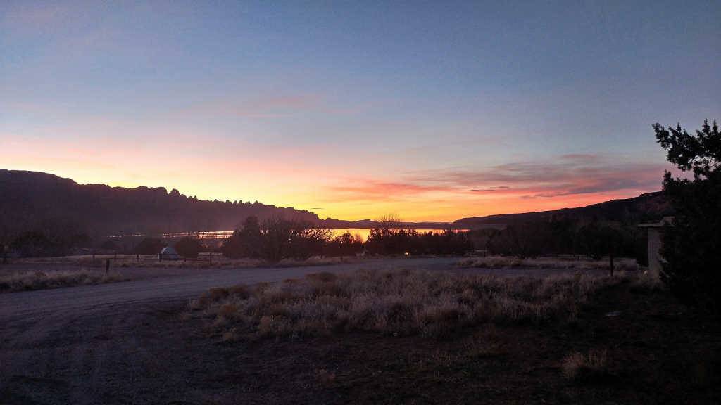 Sun setting in the distance, viewed from Ken's Lake Campground south of Moab, Utah