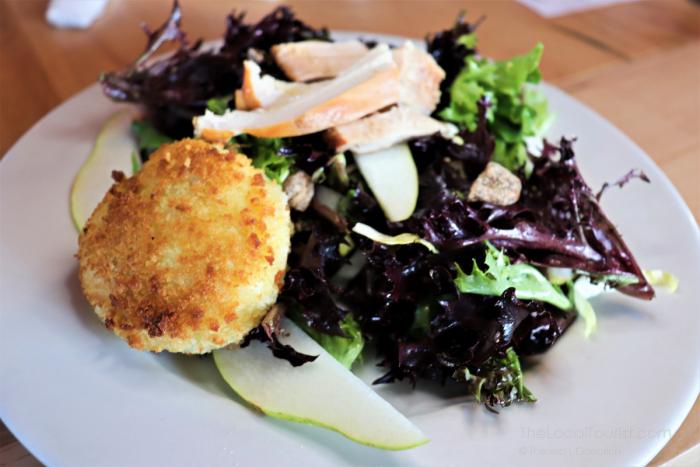 Round Barn Brewery & Public House Salad made with local goat cheese from Fennville, smoked pheasant, fresh pears, and champagne vinaigrette.