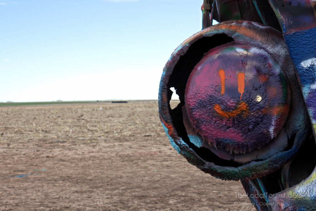 Happy face painted on the rear tire of a Cadillace