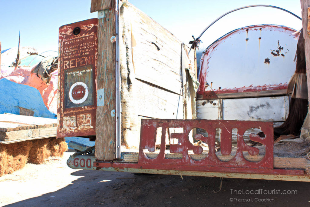 Metal stencil of JESUS on back of truck