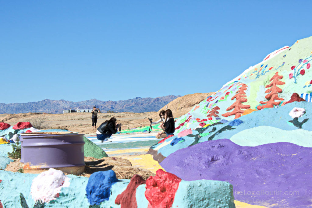Young women taking photos at Salvation Mountain