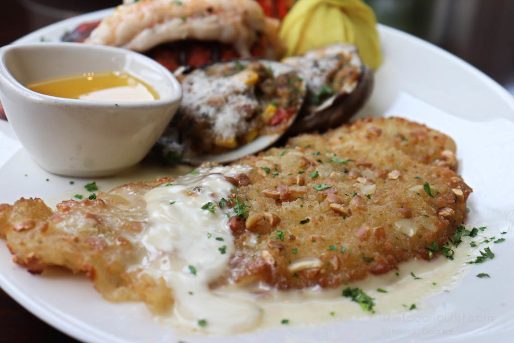 cold water lobster tail, savory clams casino with bacon, and delicate New England flounder coated in an almond crust with a champagne-shallot cream sauce