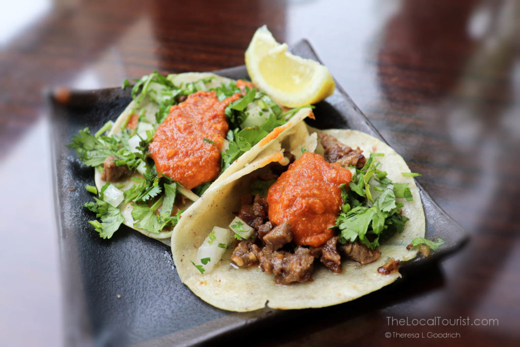 street-style carne asada tacos topped with house made salsa