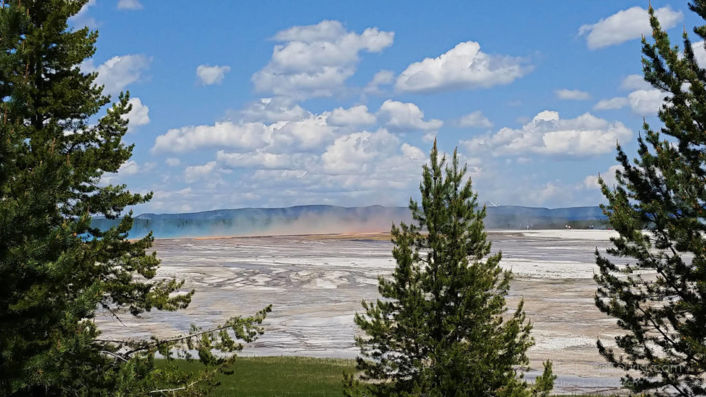 Blue and orange steam rising from Grand Prismatic Spring