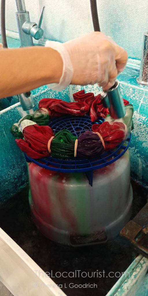 Rinsing the excess paint from my shirt at The Tie Dye Lab